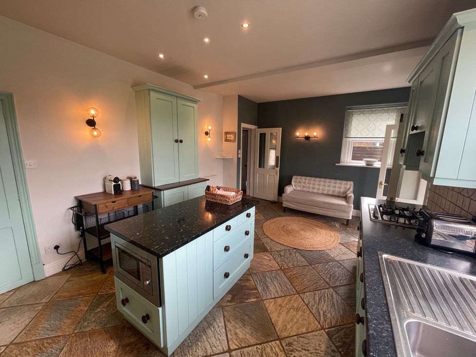A kitchen with an island and stove at Montclair in Buxton