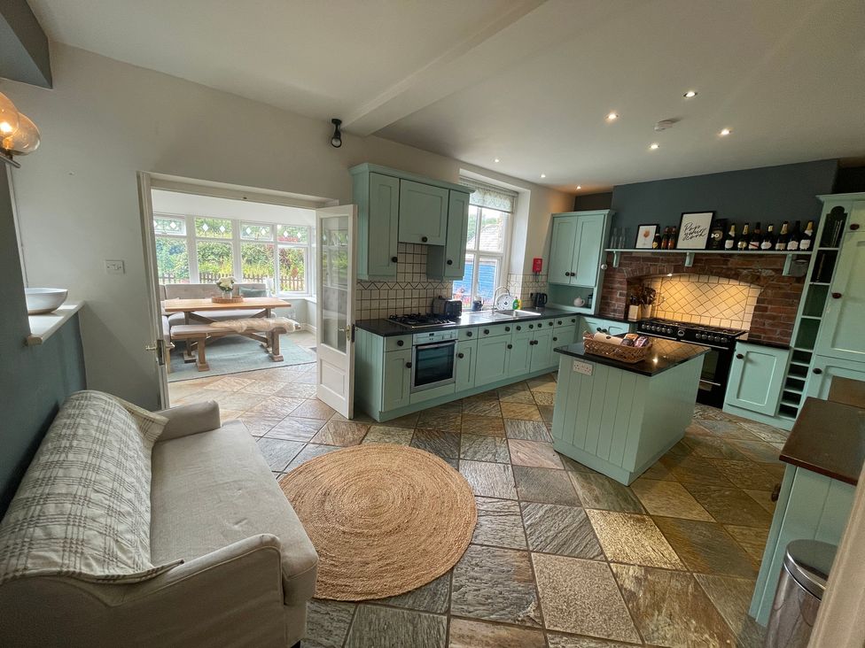 A kitchen with blue cabinets and a table in the background at Montclair Buxton