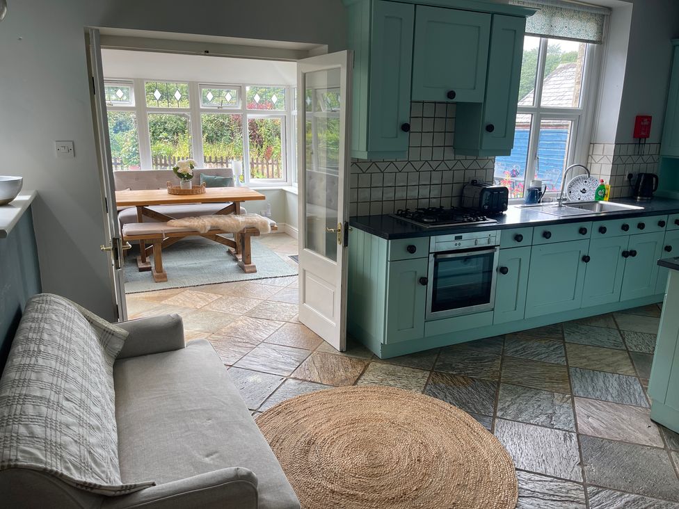 A kitchen with a dining area and a couch at Montclair in Buxton