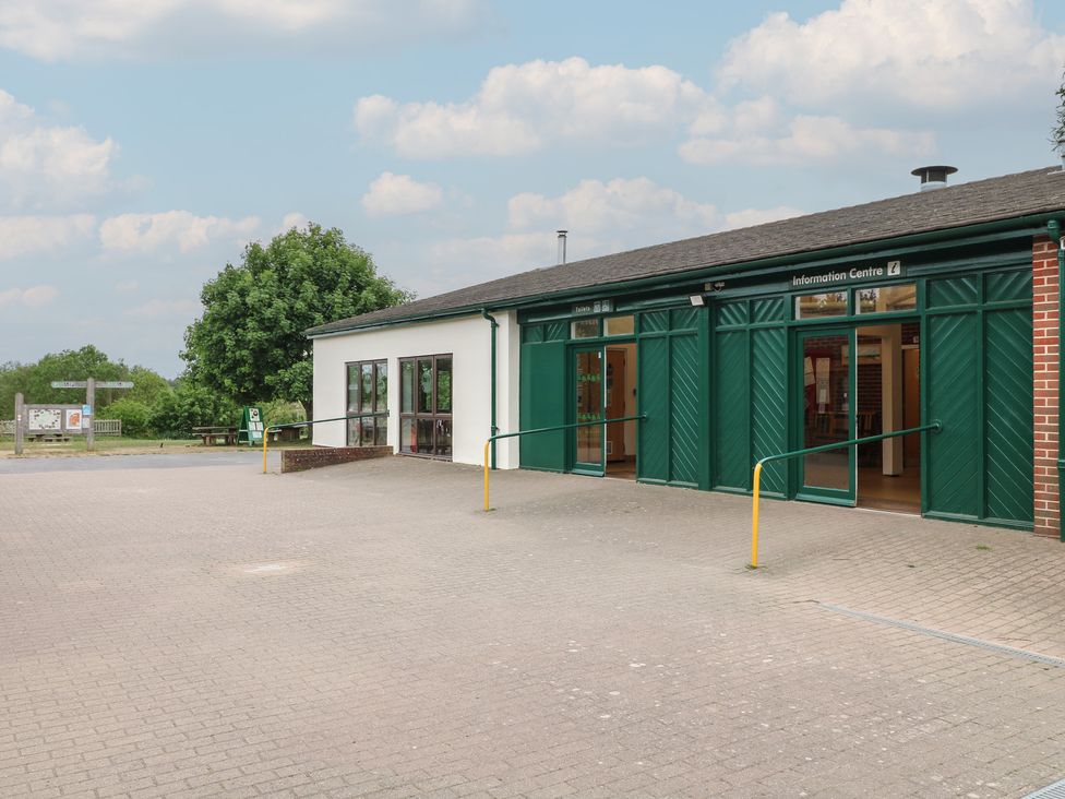 Green and white information centre building with ramps and windows in an outdoor setting at Chestnut Lodge in Rosliston