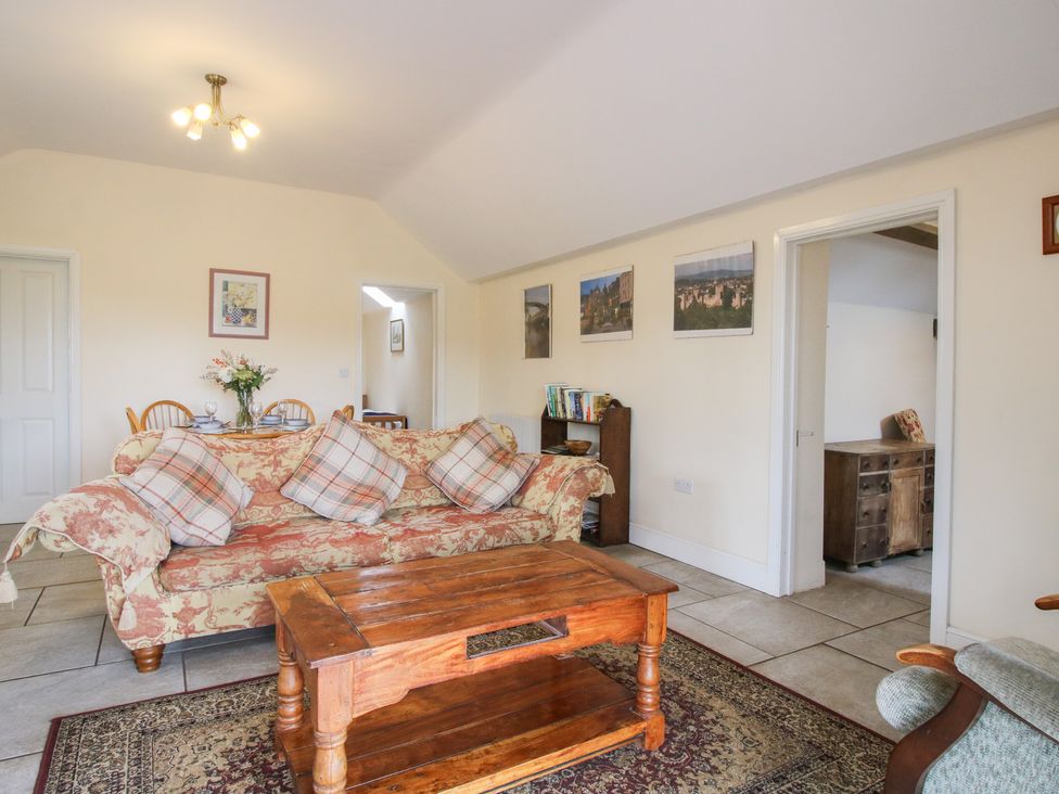 A living room with a sofa and coffee table at Millstone Cottages - Millstone Cottage, Westbury