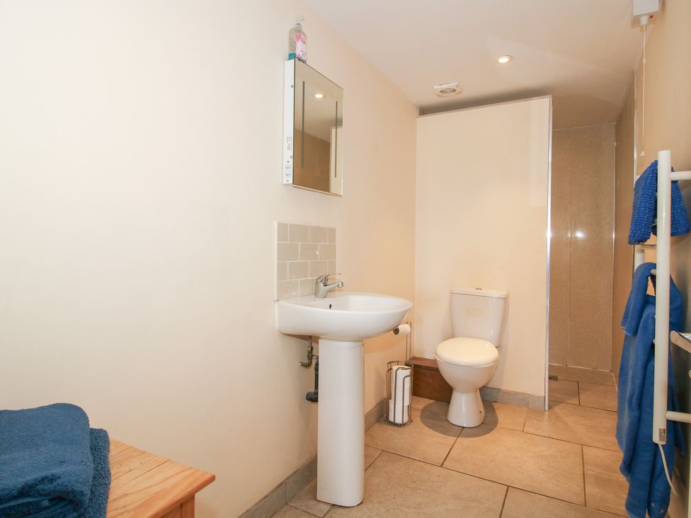 A bathroom with a sink, toilet and shower at Millstone Cottages - Millstone Cottage Westbury