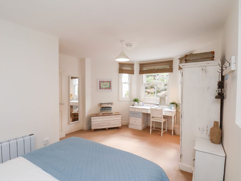 A bedroom with a bed and desk at Happy Days in Scarborough