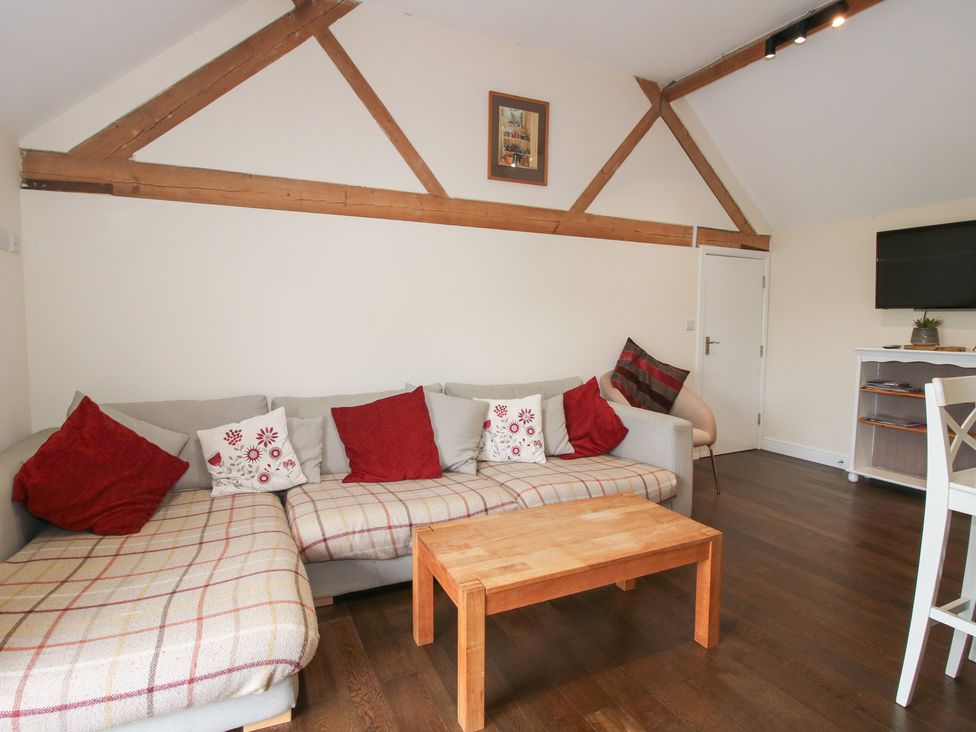 A living room with a sofa and coffee table at Millstone Cottages - Breidden View in Westbury