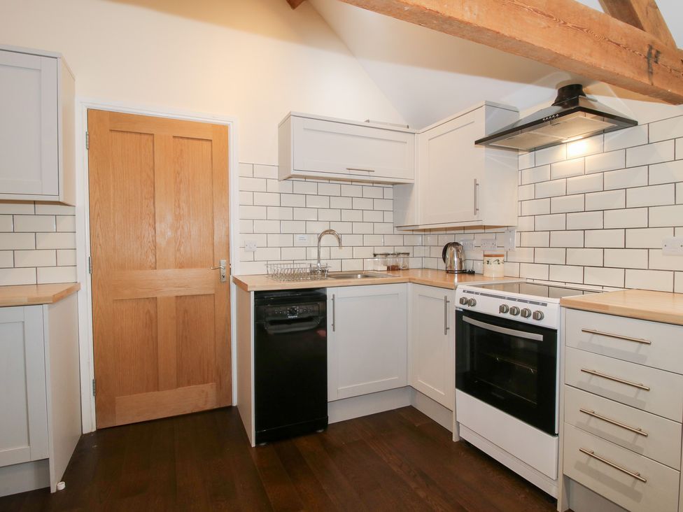 A kitchen with an oven and sink at Millstone Cottages - Breidden View Westbury
