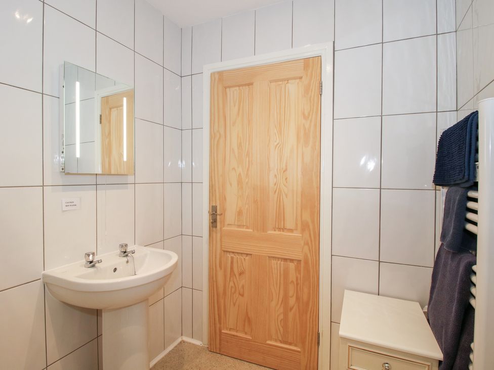 A bathroom with a sink and mirror at Millstone Cottages - Breidden View Westbury
