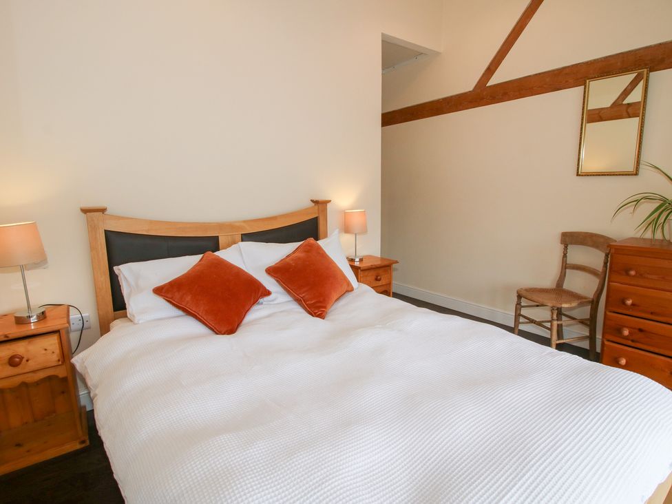 A bedroom with a bed and furniture at Millstone Cottages - Breidden View Westbury