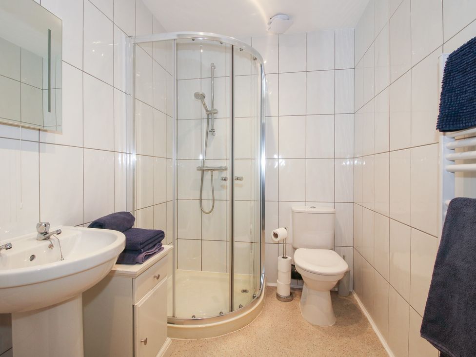 A bathroom with a shower, toilet, and sink at Millstone Cottages - Breidden View in Westbury
