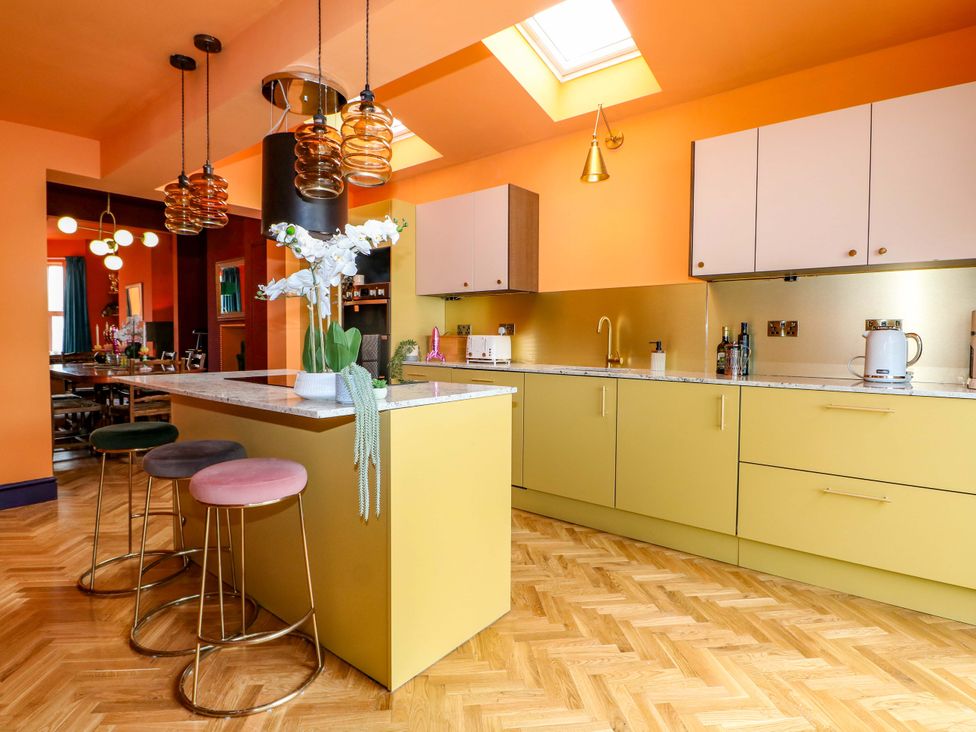 A kitchen with an island and bar stools at Hasting Heights in Hastings
