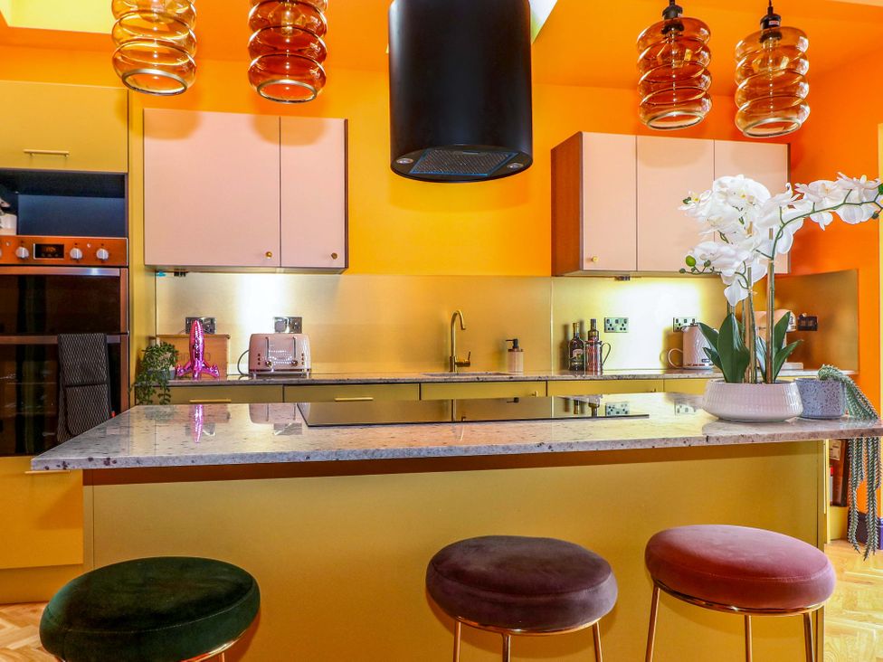 A kitchen with an island and bar stools at Hasting Heights in Hastings