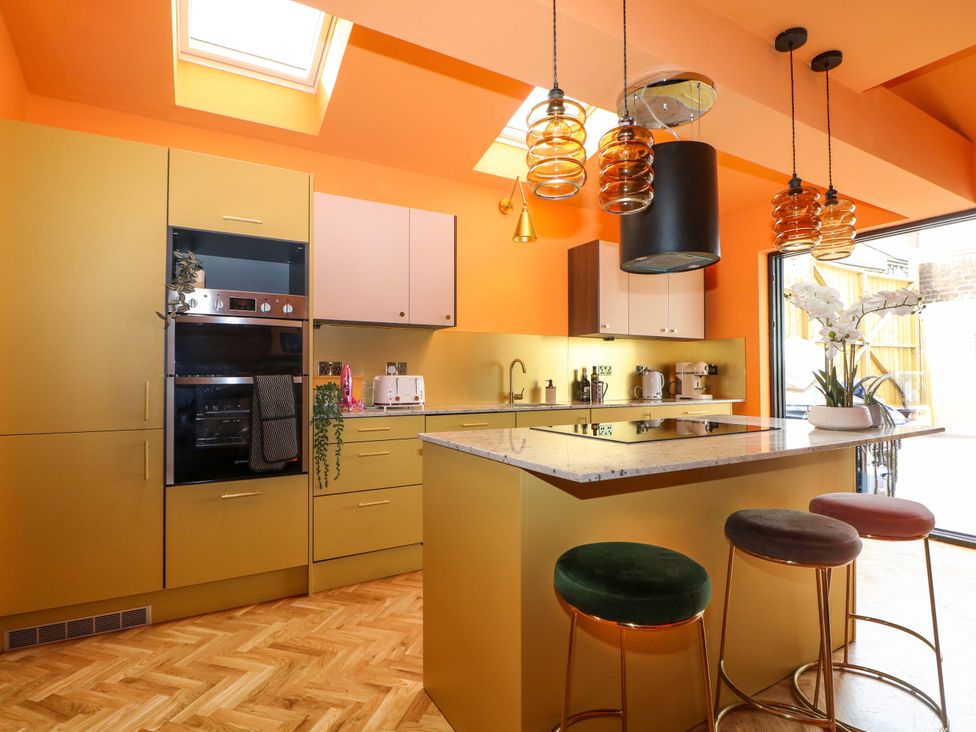 A kitchen with yellow cabinets and a countertop at Hasting Heights in Hastings