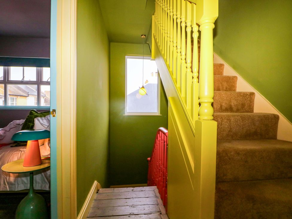 A hallway with stairs and a window at Hasting Heights in Hastings