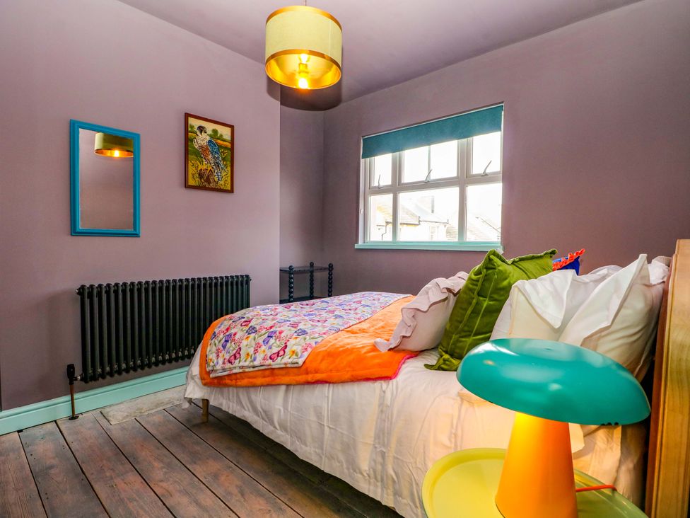 A bedroom with a bed and lamp at Hasting Heights in Hastings
