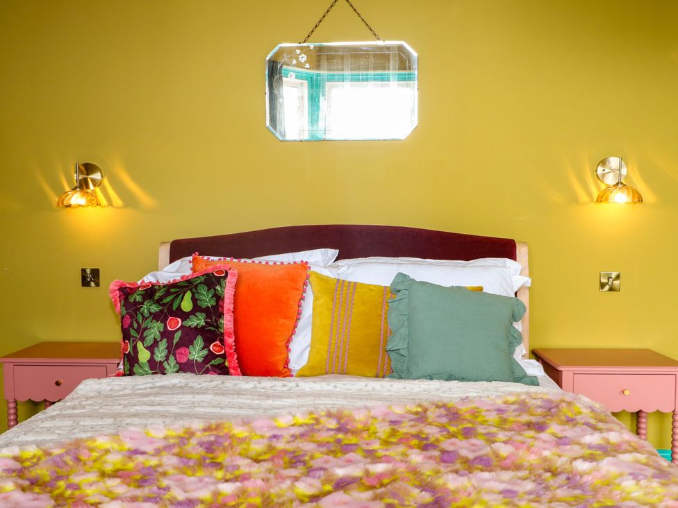 A bedroom with a bed, pillows, and a nightstand at Hasting Heights in Hastings