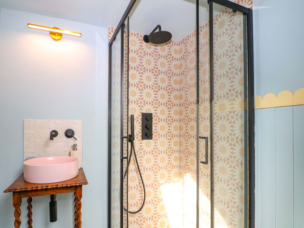 A bathroom with a shower and a sink at Hasting Heights in Hastings