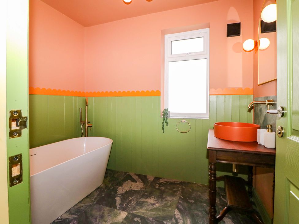 A bathroom with a bathtub and sink at Hasting Heights in Hastings
