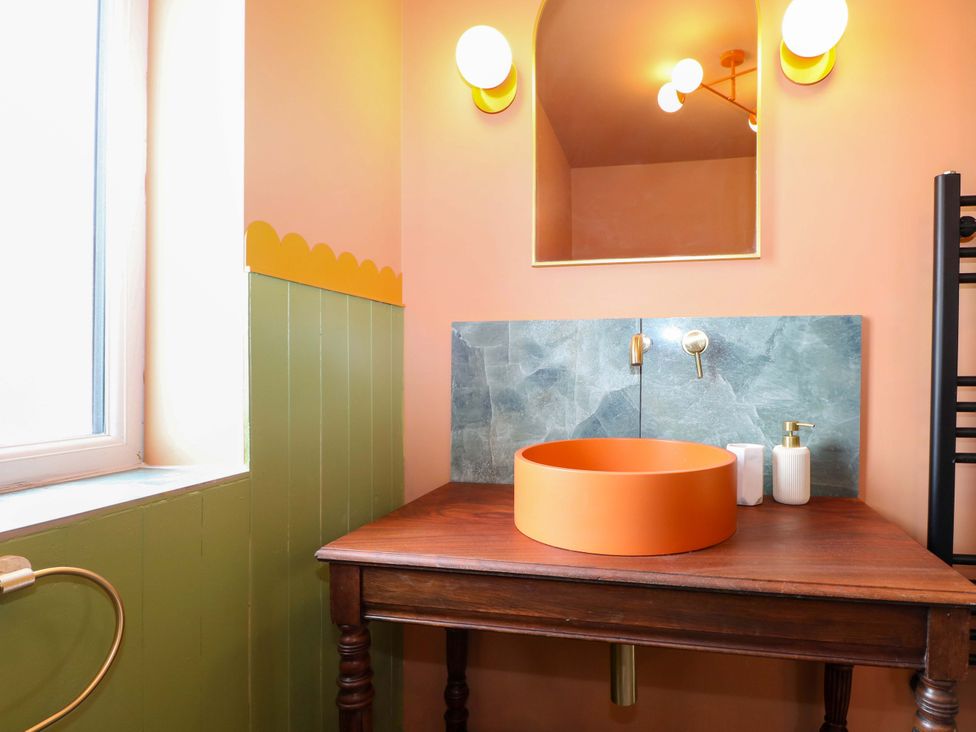 A bathroom with a wooden table and sink at Hasting Heights in Hastings