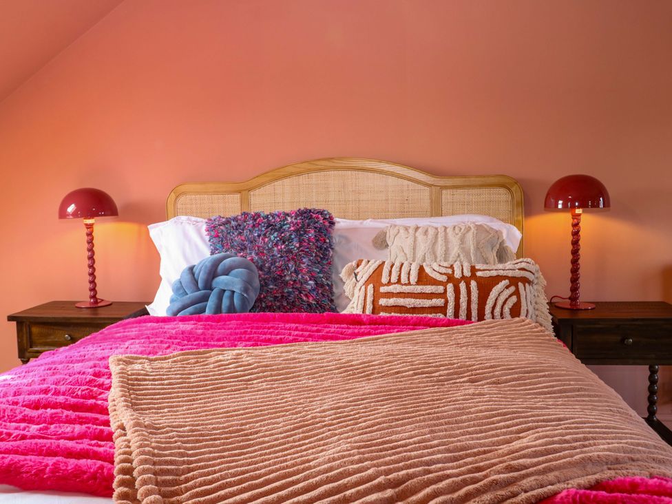 A bedroom with a bed and bedside tables at Hasting Heights in Hastings