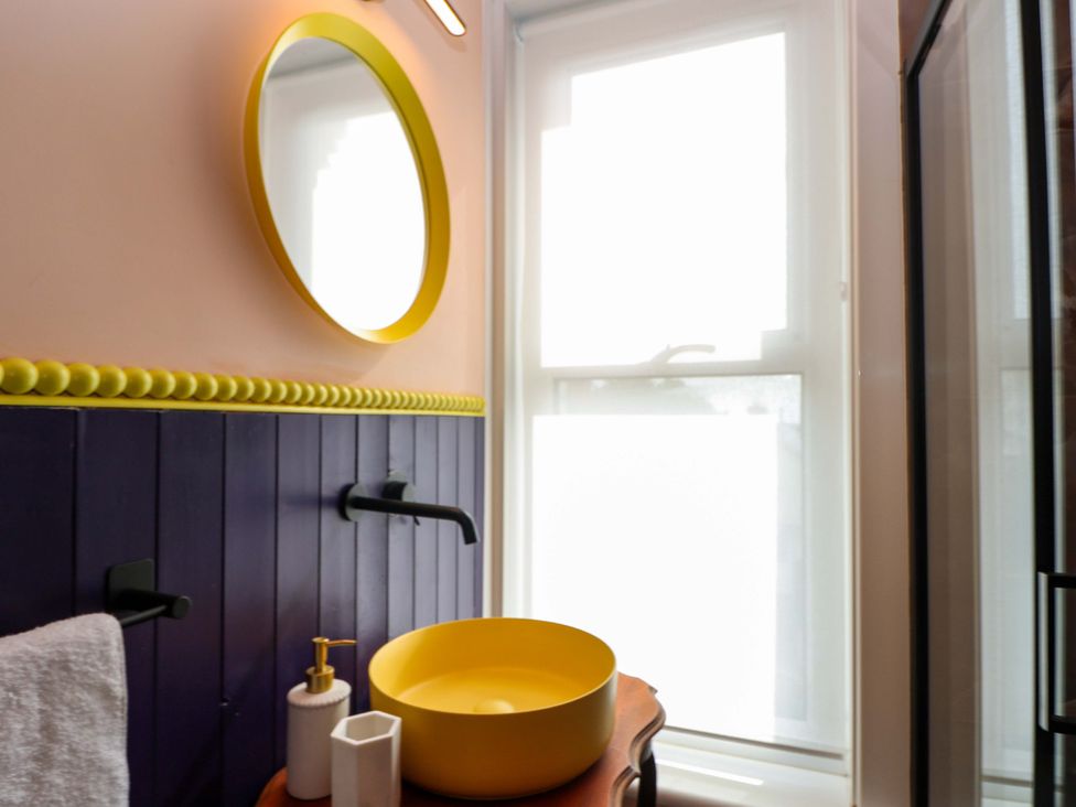 A bathroom with a sink and mirror at Hasting Heights in Hastings