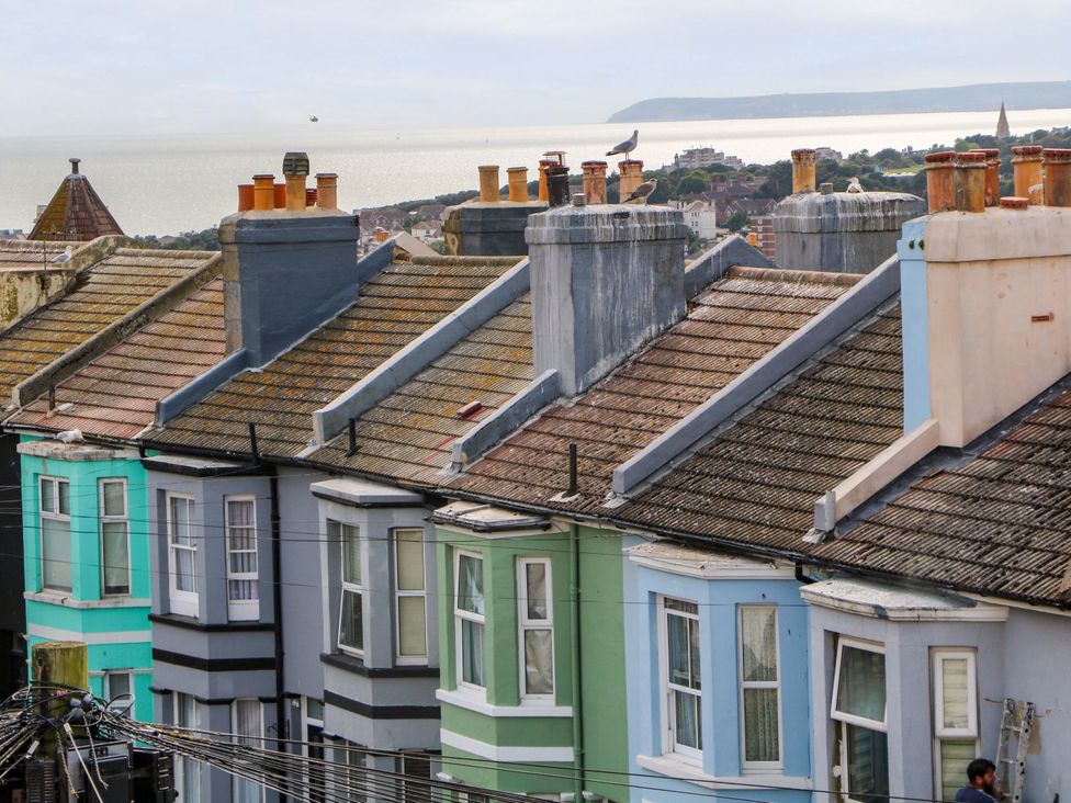 A view of rooftops and chimneys overlooking the sea at Hasting Heights in Hastings