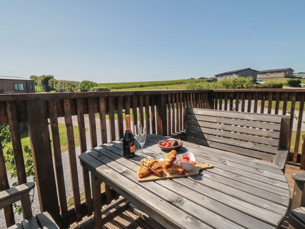 A table with food and drinks on a deck at Maple Lodge in Whitby