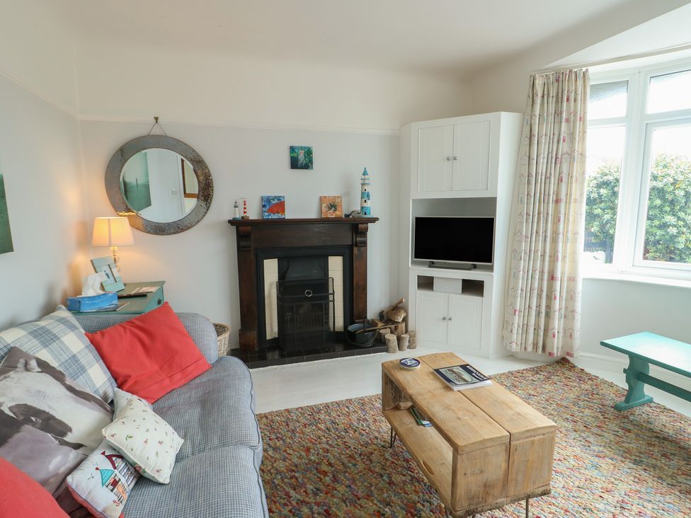A living room with a fireplace and a coffee table at Gorse Hill in 