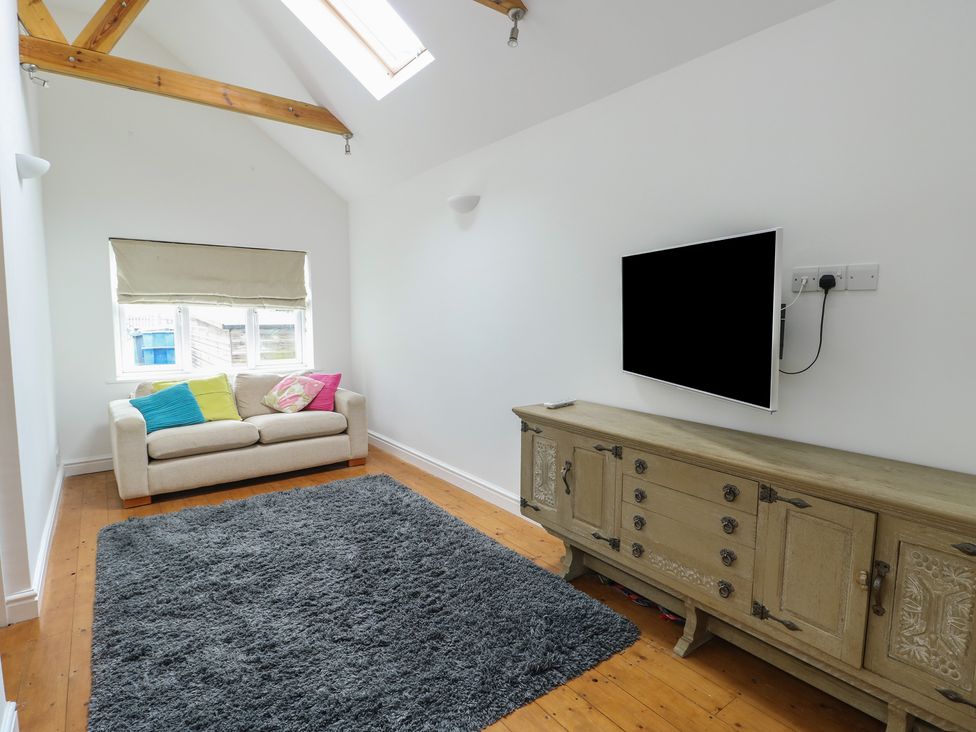 A living room with a sofa and television at Gorse Hill 
