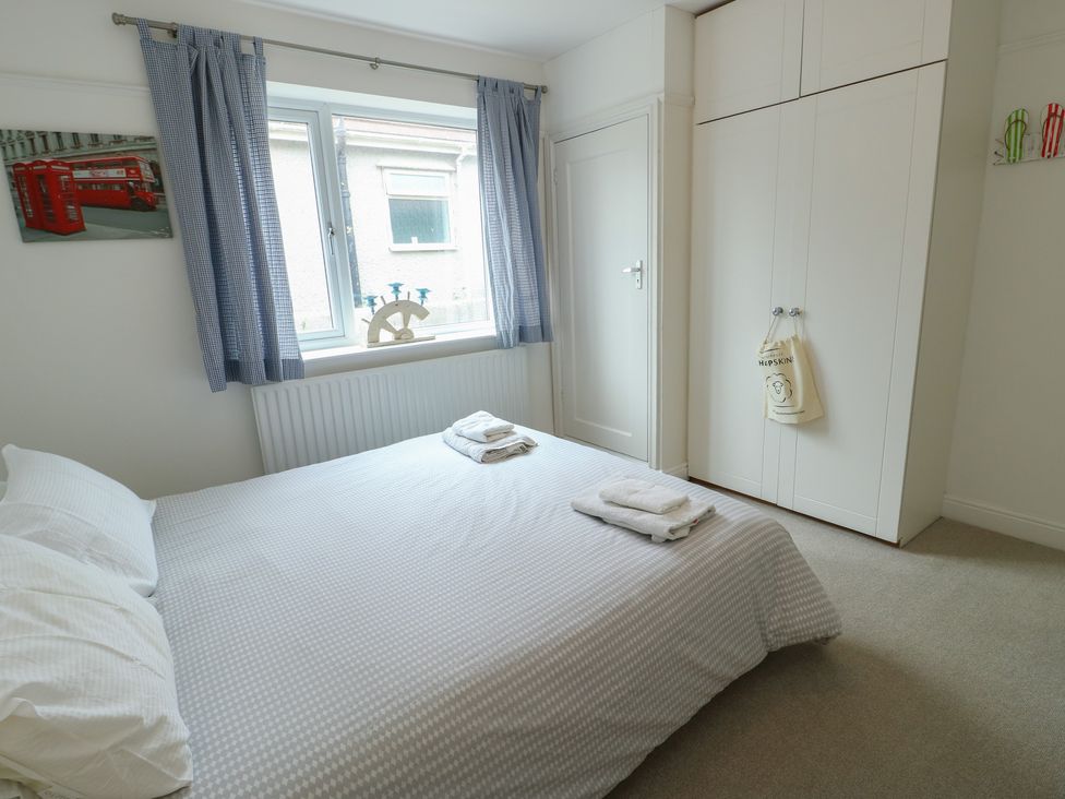 A bedroom with a bed and wardrobe at Gorse Hill