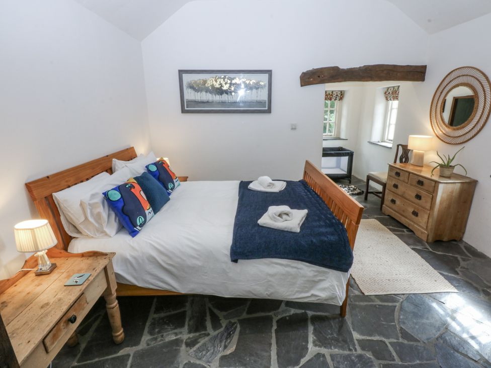 A bedroom with a bed and a chest of drawers at Tyddyn Iolyn in Benllech