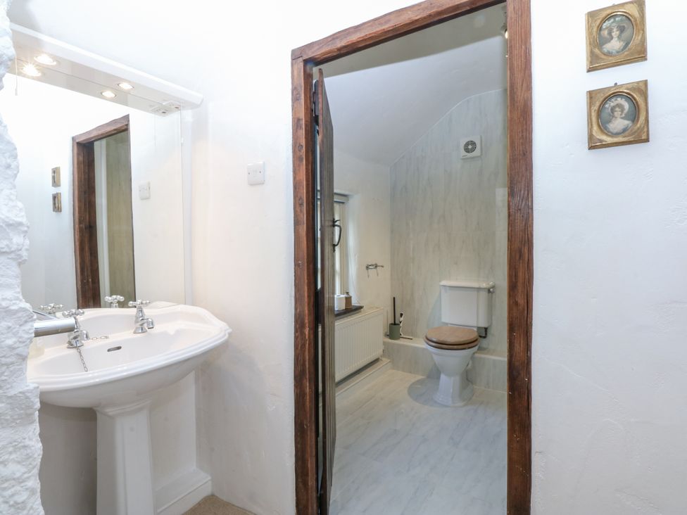 A bathroom with a sink and toilet at Tyddyn Iolyn in Benllech