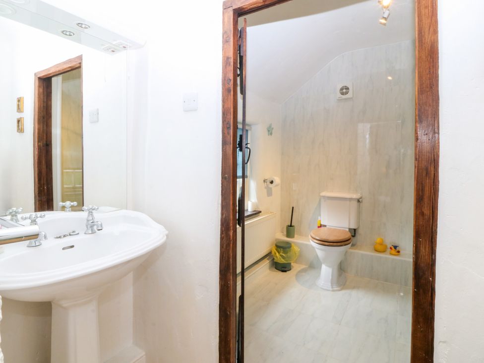 A bathroom with a sink and toilet at Tyddyn Iolyn in Benllech
