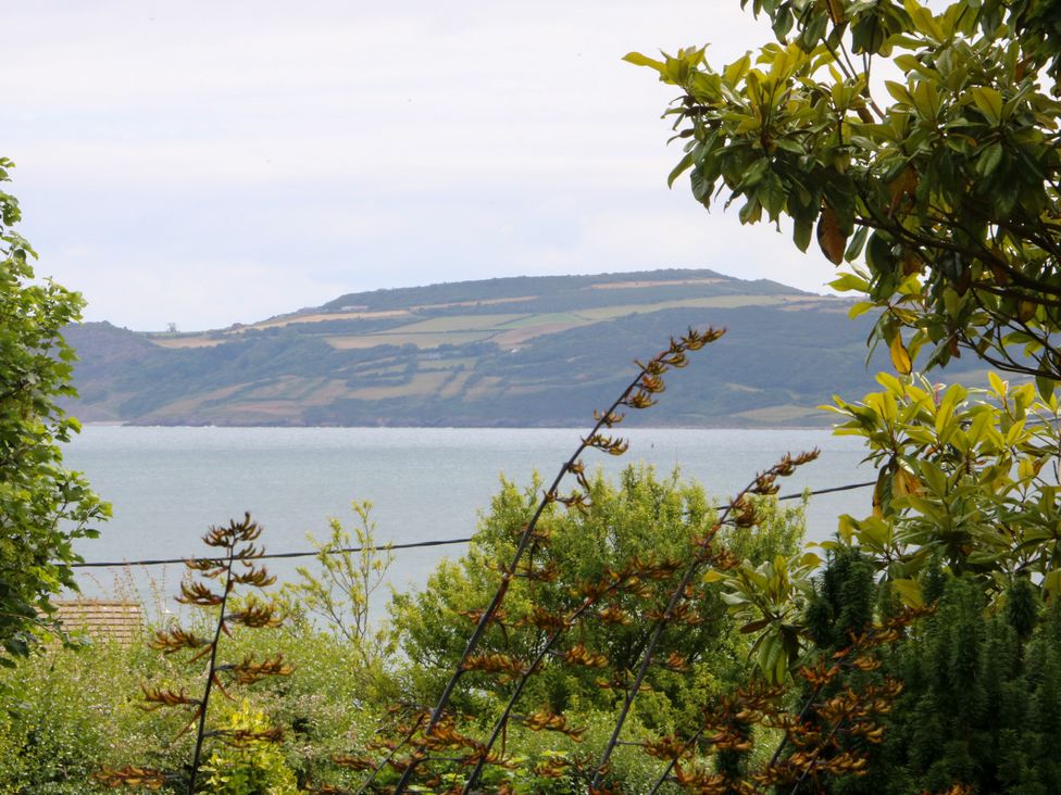 View of water and land with trees at Tyddyn Iolyn in Benllech
