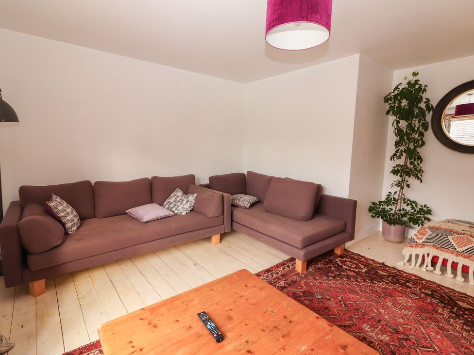 A living room with a sofa and coffee table at Shanti Gher in Bantry