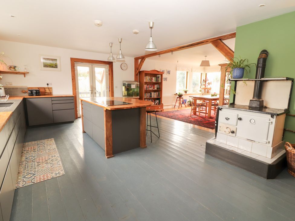 A kitchen with an island and dining area at Shanti Gher in Bantry