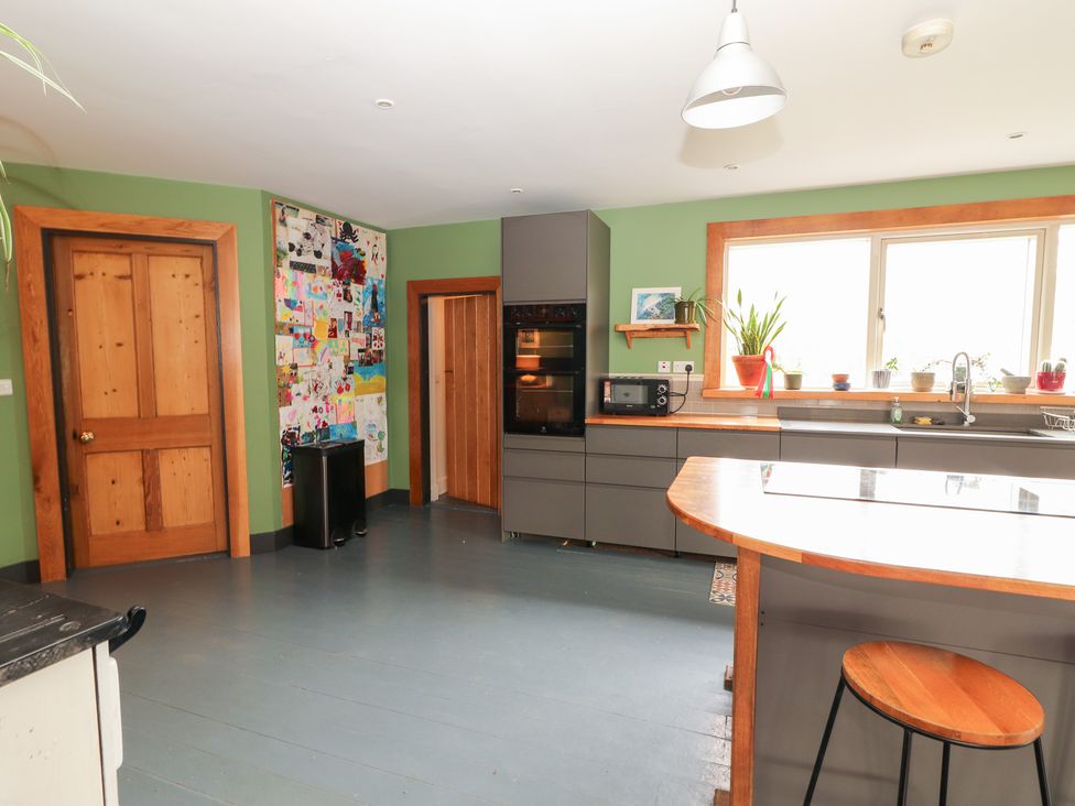 A kitchen with appliances and a bar stool at Shanti Gher in Bantry