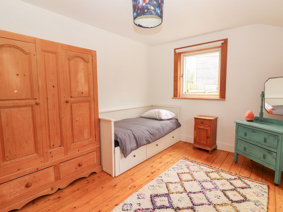 A bedroom with a bed and wardrobe at Shanti Gher in Bantry