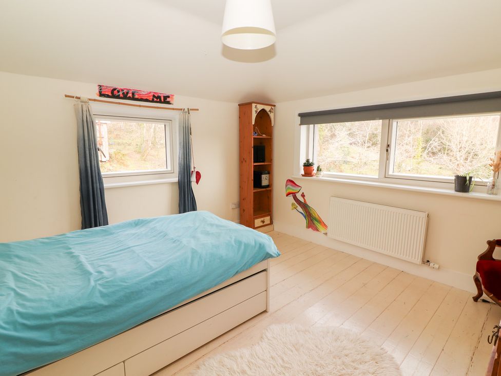 A bedroom with a bed and shelf at Shanti Gher in Bantry