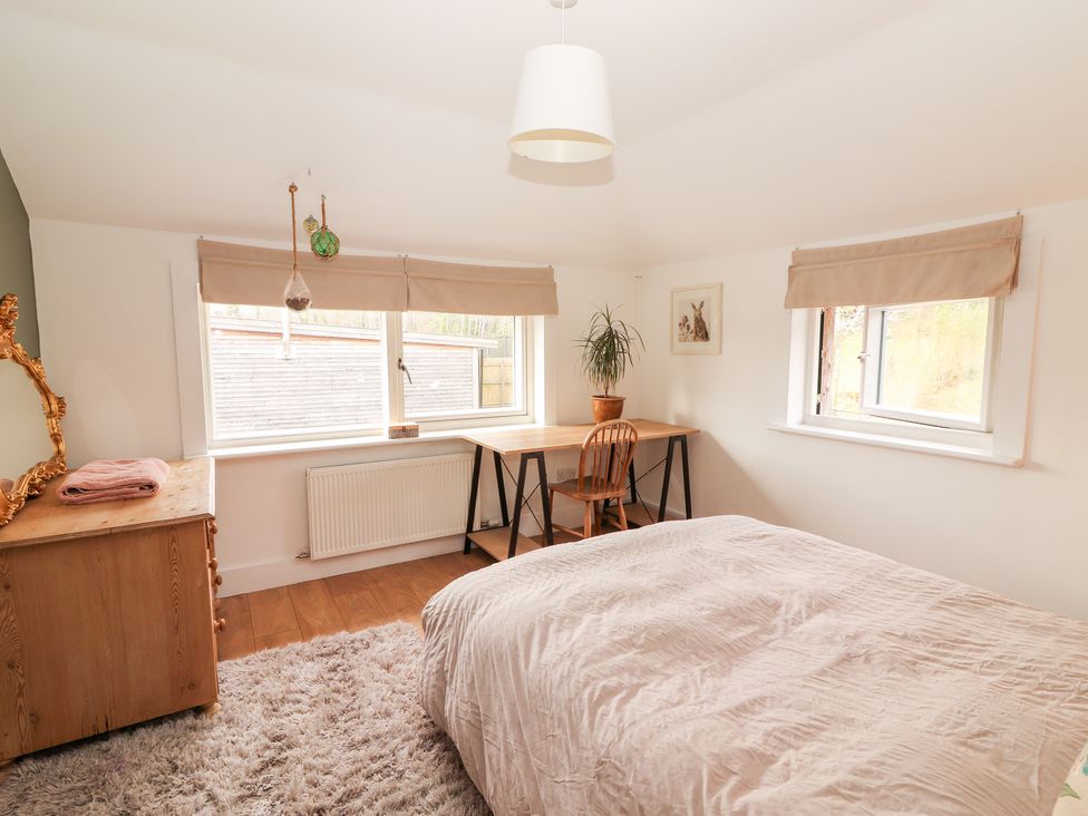 A bedroom with a bed and desk at Shanti Gher in Bantry