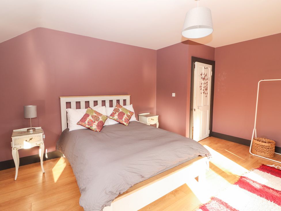 A bedroom with a bed and bedside table at Shanti Gher in Bantry