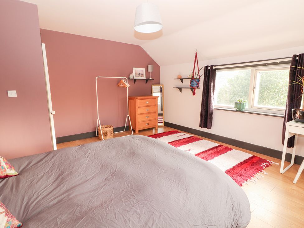 A bedroom with a bed and a wooden drawer at Shanti Gher in Bantry