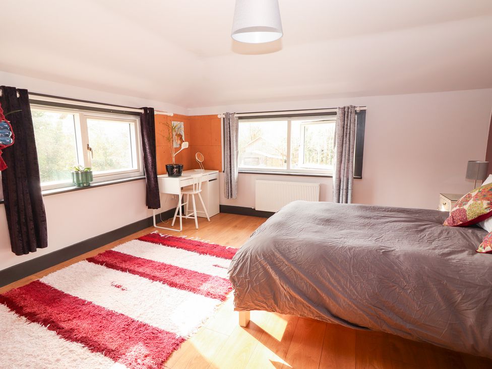 A bedroom with a bed and desk at Shanti Gher in Bantry