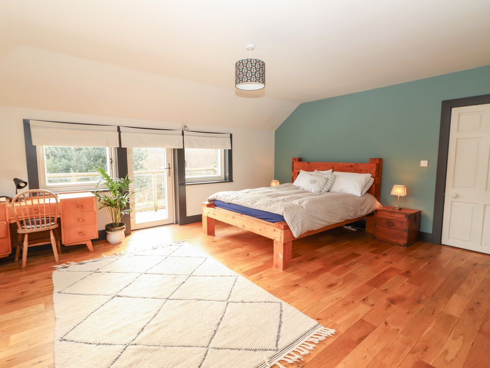 A bedroom with a bed and desk at Shanti Gher in Bantry