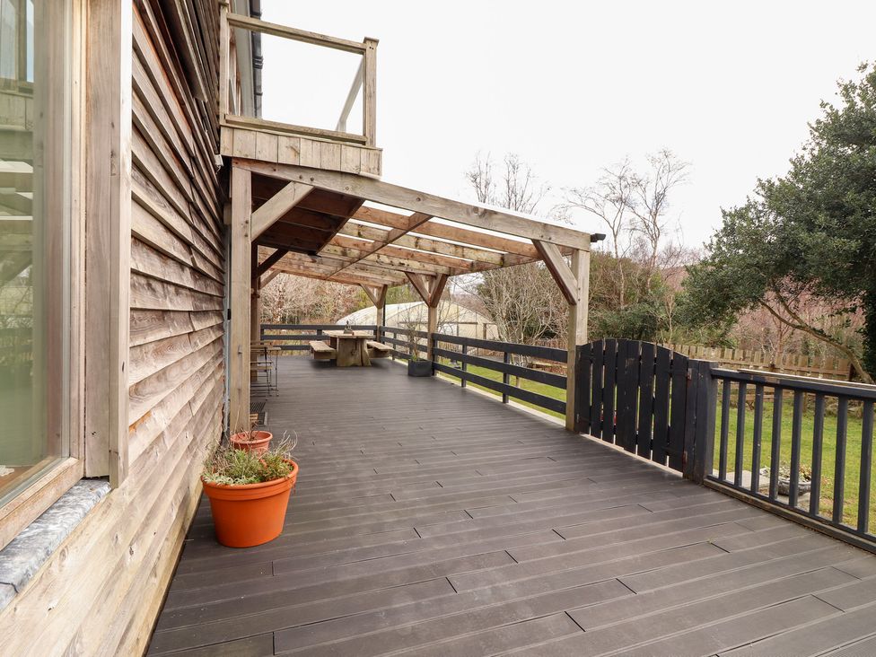 An outdoor deck with wooden structure and potted plants at Shanti Gher in Bantry