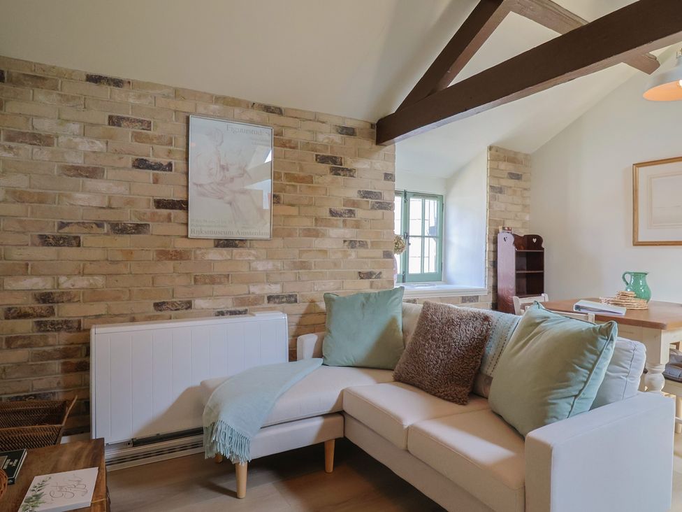 A living room with a sofa and table at Drake's Hideaway in Lyme Regis
