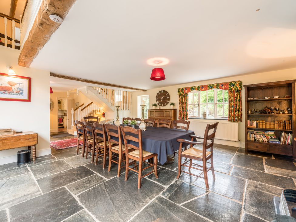A dining room with a large table and chairs at The Coach House in Lydford