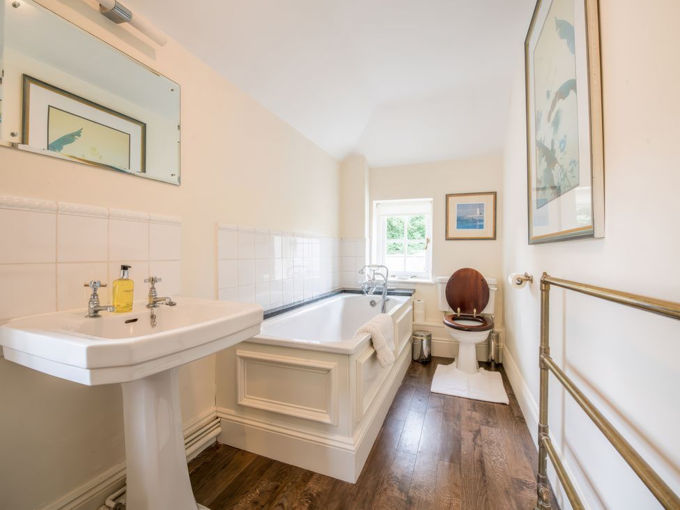 A bathroom with a sink and bath tub at The Coach House in Lydford