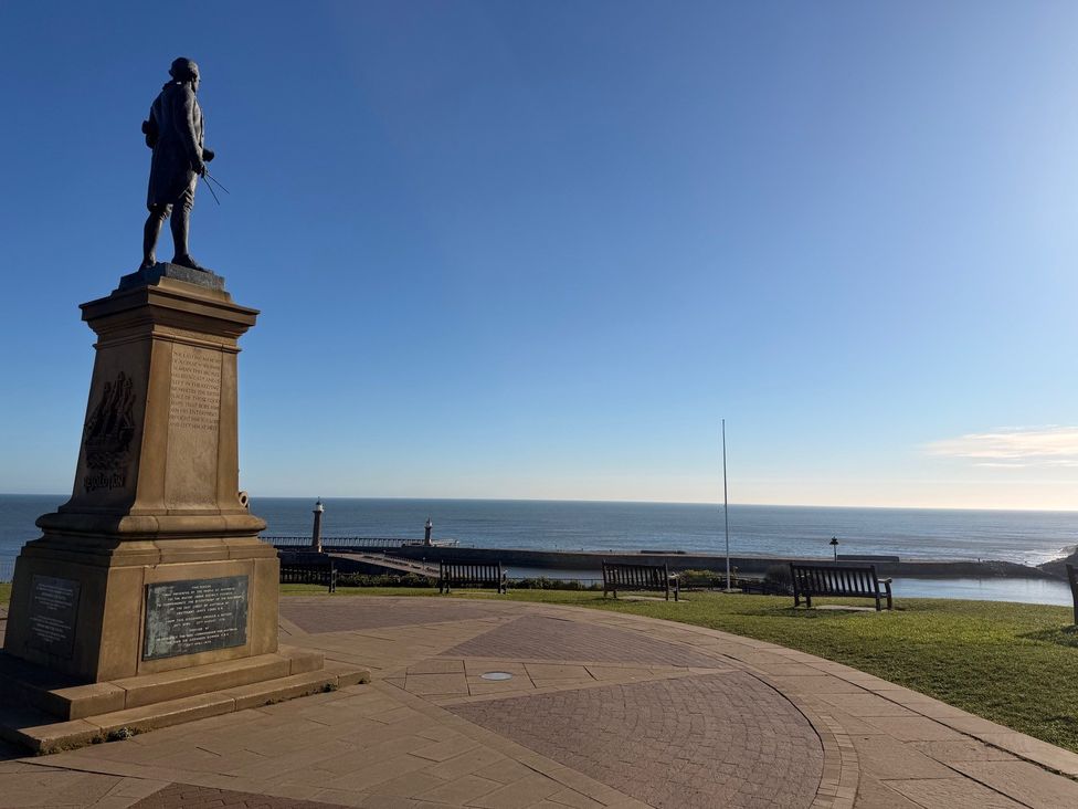 A statue overlooking the sea at Pebble Cottage in Whitby