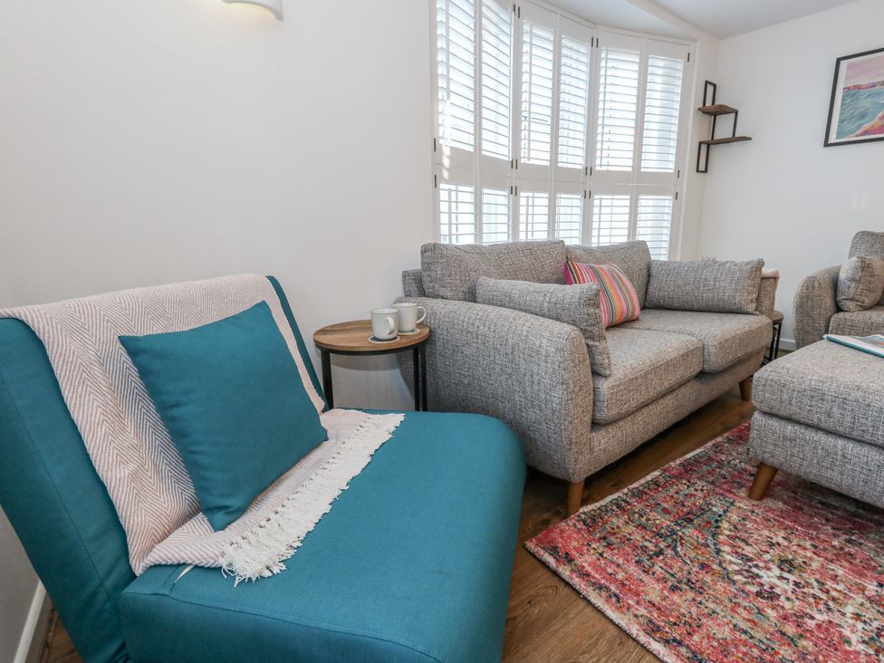 A living room with a sofa and armchair at Betty's Buoy in Weymouth