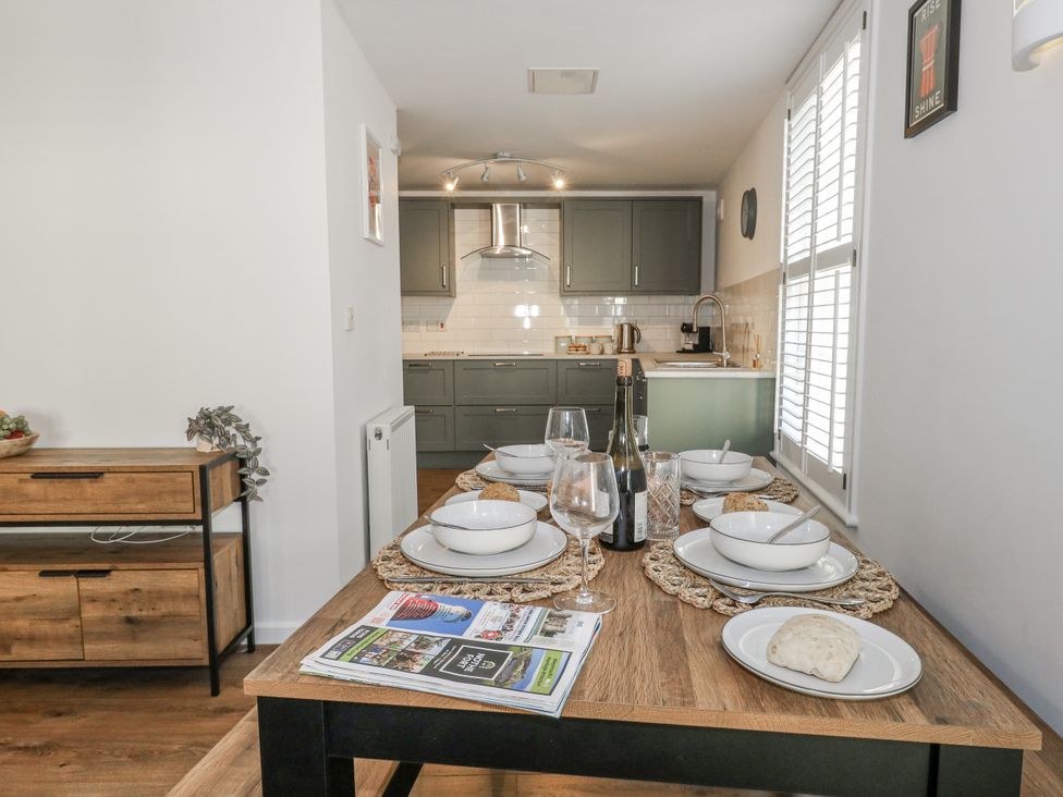 A dining room with a table set for a meal at Betty's Buoy in Weymouth
