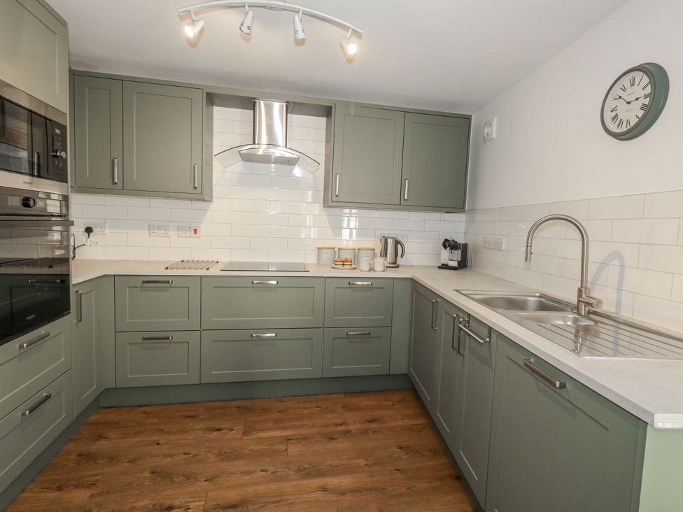 A kitchen with cabinets and appliances at Betty's Buoy in Weymouth